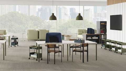 Open floor collaborative and focus space with project tables, mobile storage, privacy hoods and lounge seating.