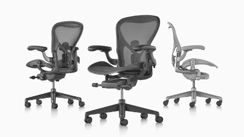Three Aeron office chairs viewed from different angles.
