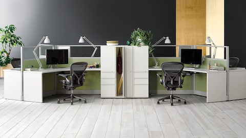 Black Aeron ergonomic desk chairs at Action Office 120 degree workstations with task lighting.