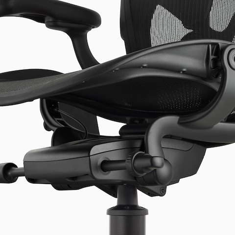 A close-up view of the adjustment options on a black Aeron Stool.