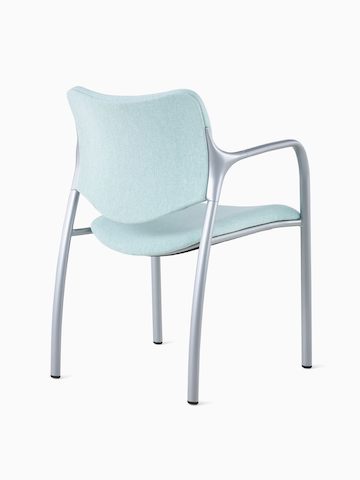 An Aside Chair with light green upholstered seat and back, viewed from the back at an angle.