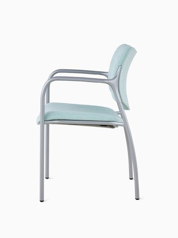An Aside Chair with light green upholstered seat and back, viewed from the side.