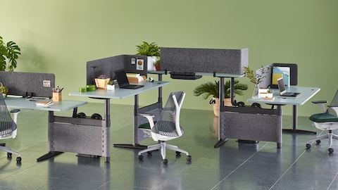 Sayl office chairs complement a zigzag configuration of four height-adjustable Atlas Office Landscape desks with blue tops.