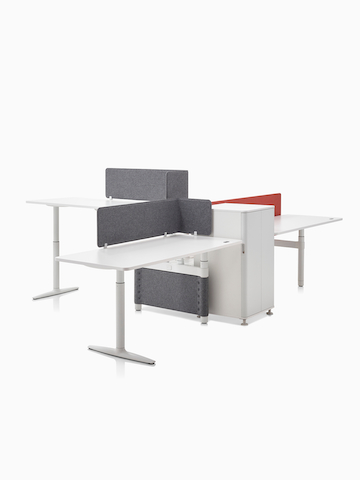 A collaboration cluster of three height-adjustable Atlas Office Landscape desks with gray privacy screens.