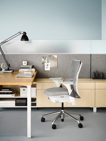 Gray Sayl chair with gray fabric seat at a Canvas Office Landscape individual workstation. Select to go to our individual workstations page.