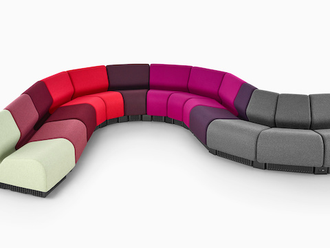 Chadwick Modular Seating modules in gray and various shades of red and purple, arranged in a serpentine configuration.