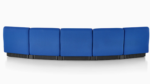 Five blue Chadwick Modular Seating modules arranged to form a gentle curve, viewed from the rear to show the upholstered back.