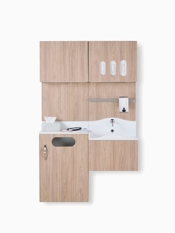 Compass system casework wall unit in medium wood laminate finish with integrated storage and wash sink.