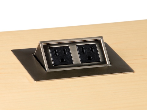 A two-outlet Connect power port mounted into a woodgrain work surface.