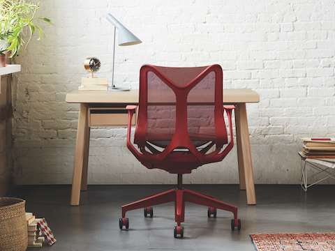 A small office with a Canyon red Cosm low-back chair in front of a Distil desk in ash. 