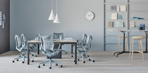 Glacier light blue Cosm Chairs around a table in an office.