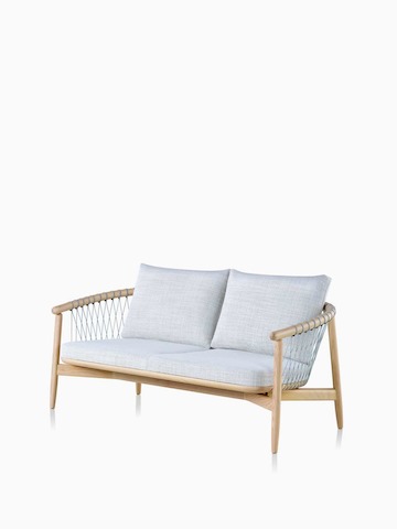 A light-colored Crosshatch Settee featuring gray upholstery and a white ash frame. Select to go to the Crosshatch Settee product page.