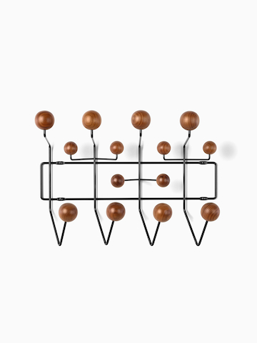 An Eames Hang-It-All storage rack with wood knobs.