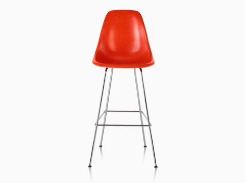 Upper half of a red Eames Molded Fiberglass Stool, viewed from the front. 