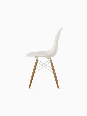 White Eames Molded Plastic side chair with a blue upholstered seat pad and dowel legs, viewed from a 45-degree angle.