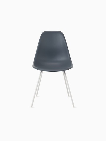 Light brown Eames Molded Plastic side chair with a wire base, viewed from the side.