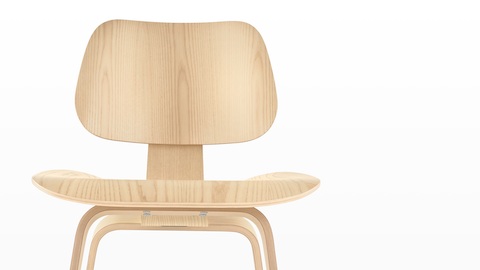 Close view of the upper half of an Eames Molded Plywood Chair with a light finish.