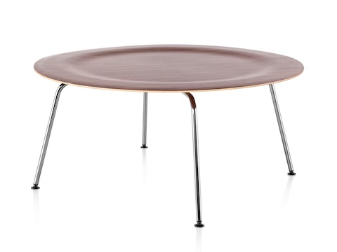 Una mesa de centro de madera contrachapada moldeada redonda de Eames con las piernas del metal y una tapa dentada en un final medio.