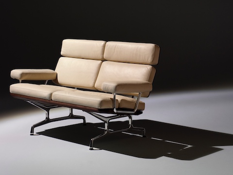 Ivory-colored Eames loveseat, viewed from a 45-degree angle. 