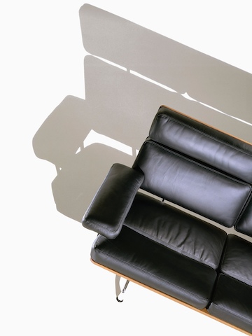 Overhead view of a partial black leather Eames Sofa. 