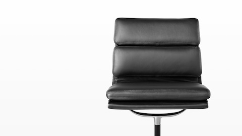 The plush seat and back cushions on a black leather Eames Soft Pad Chair, viewed from the front.