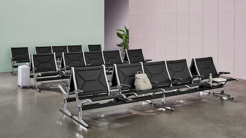Multiple rows of Eames Tandem Sling Seating in a public waiting area.