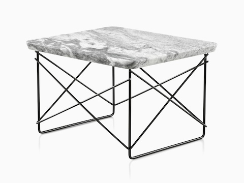 An angled view of an Eames Wire Base Low Table with a stone top. 
