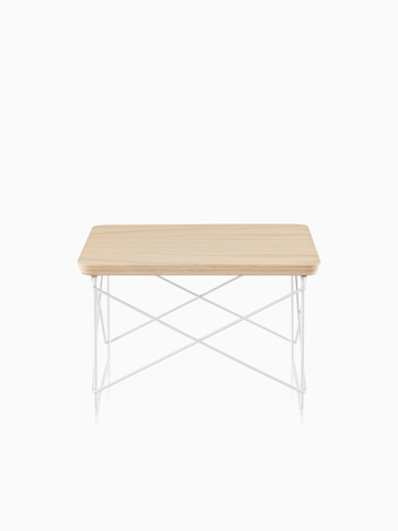 A rectangular Eames Wire Base Low Table with a light wood finish.