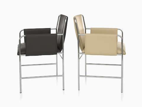 Side view of two Envelope Chairs back-to-back, one with black upholstery and one with tan upholstery.