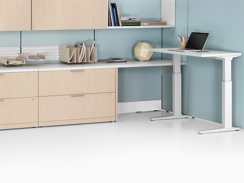 Ethospace workspace with high dividing walls, low and high lateral storage units, and height-adjustable desk.