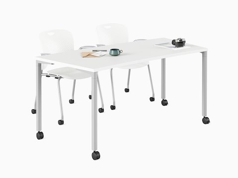 White classroom curve Everywhere Table with a pair of Caper stacking chairs.