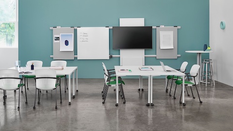 A workshop setting with Everywhere training tables, Exclave boards, and white and green Keyn Chairs.