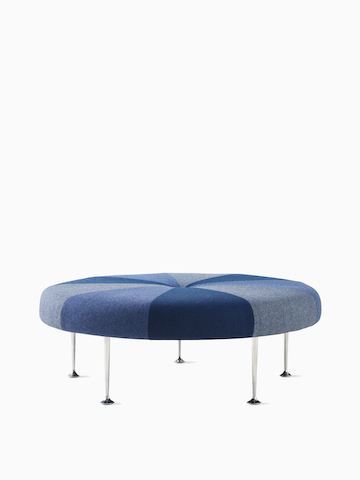 A Girard Colour Wheel Ottoman upholstered in blue fabrics, viewed from the side.