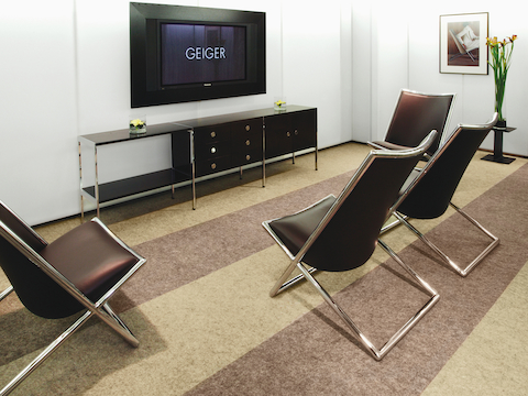 An office lounge featuring an H Frame Credenza and four Scissor Chairs. 