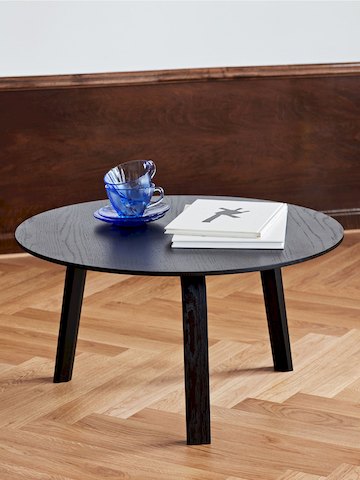 Black Bella Coffee Table standing alone, holding books and dishes.