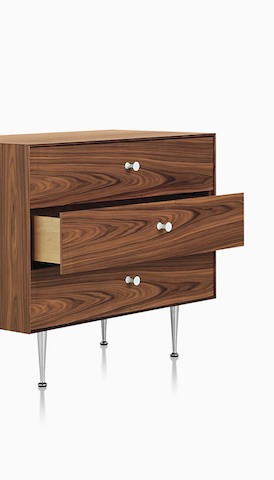 A Nelson Thin Edge chest with three drawers in a medium wood finish. Select to go to the Herman Miller storage landing page.