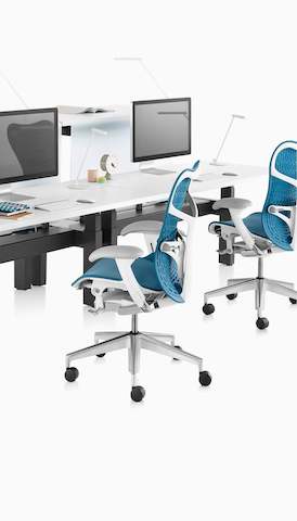 Two blue Mirra 2 office chairs in a benching application. Select to go to the Herman Miller workspaces landing page. 