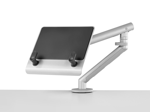 An adjustable Flo Monitor Arm supports an empty Laptop Mount, which has two brackets to hold a notebook computer.