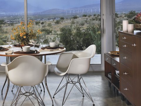 Nelson Basic Cabinet Series modular storage pieces join Eames Molded Plastic Chairs in a dining area overlooking the desert. 
