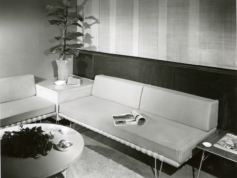 A vintage black-and-white photo of two Nelson Daybeds used as sofas in an office lobby. 