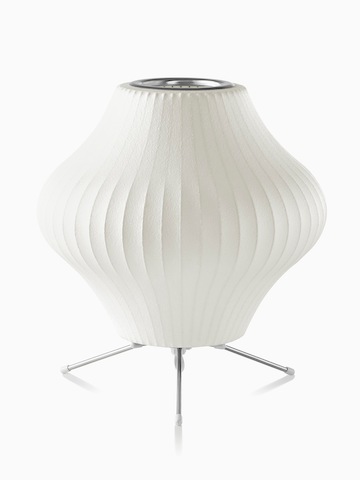 A white table lamp. Select to go to the Nelson Pear Tripod Lamp product page.