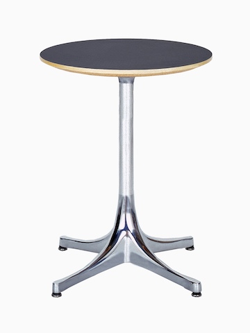 A round Nelson Pedestal Table with a black laminate top and polished aluminum base. 
