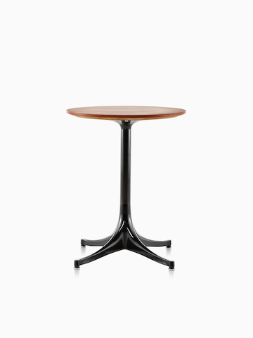 A round Nelson Pedestal Table with a medium wood finish.