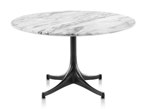 A round Nelson Pedestal outdoor coffee table with a white marble top and black base. 