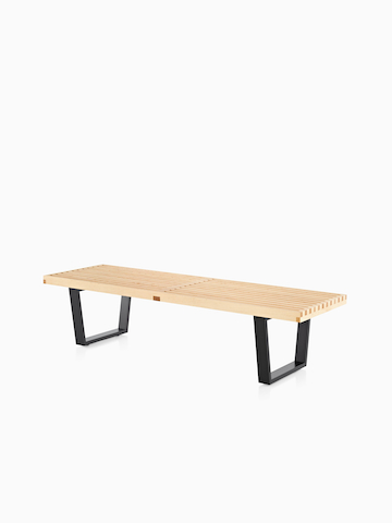Maple Nelson Platform Bench with ebonized wood legs, viewed from the front at an angle. Select to go to the Nelson Platform Bench product page.