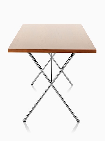 A Nelson X-Leg Table with a light veneer top and chrome legs, viewed from the narrow end. 