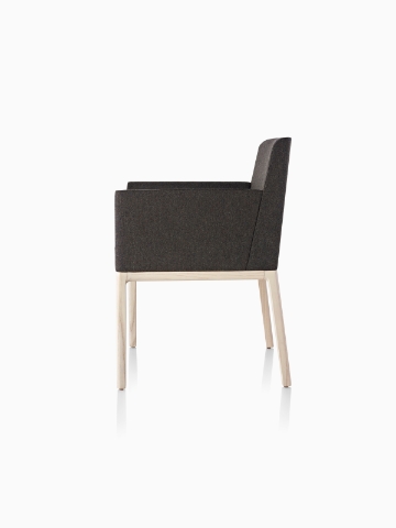 Black Nessel Chair with arms and light wood base, viewed from the side.