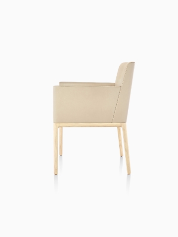 Tan Nessel Chair with arms and light wood base, viewed from the side.