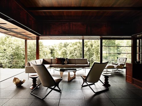 A Noguchi Table with a white ash base anchors a residential setting filled with mid-century modern pieces. 