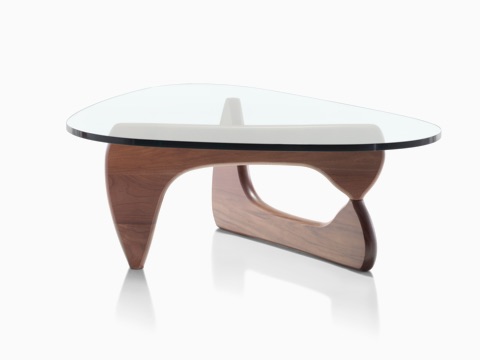 A Noguchi occasional table with a freeform glass top and curved wood base in a medium finish.